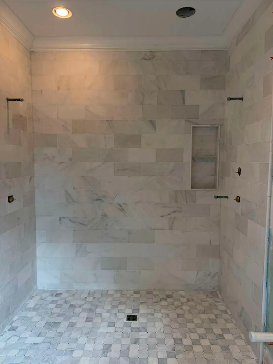 Completed marble-look tile shower