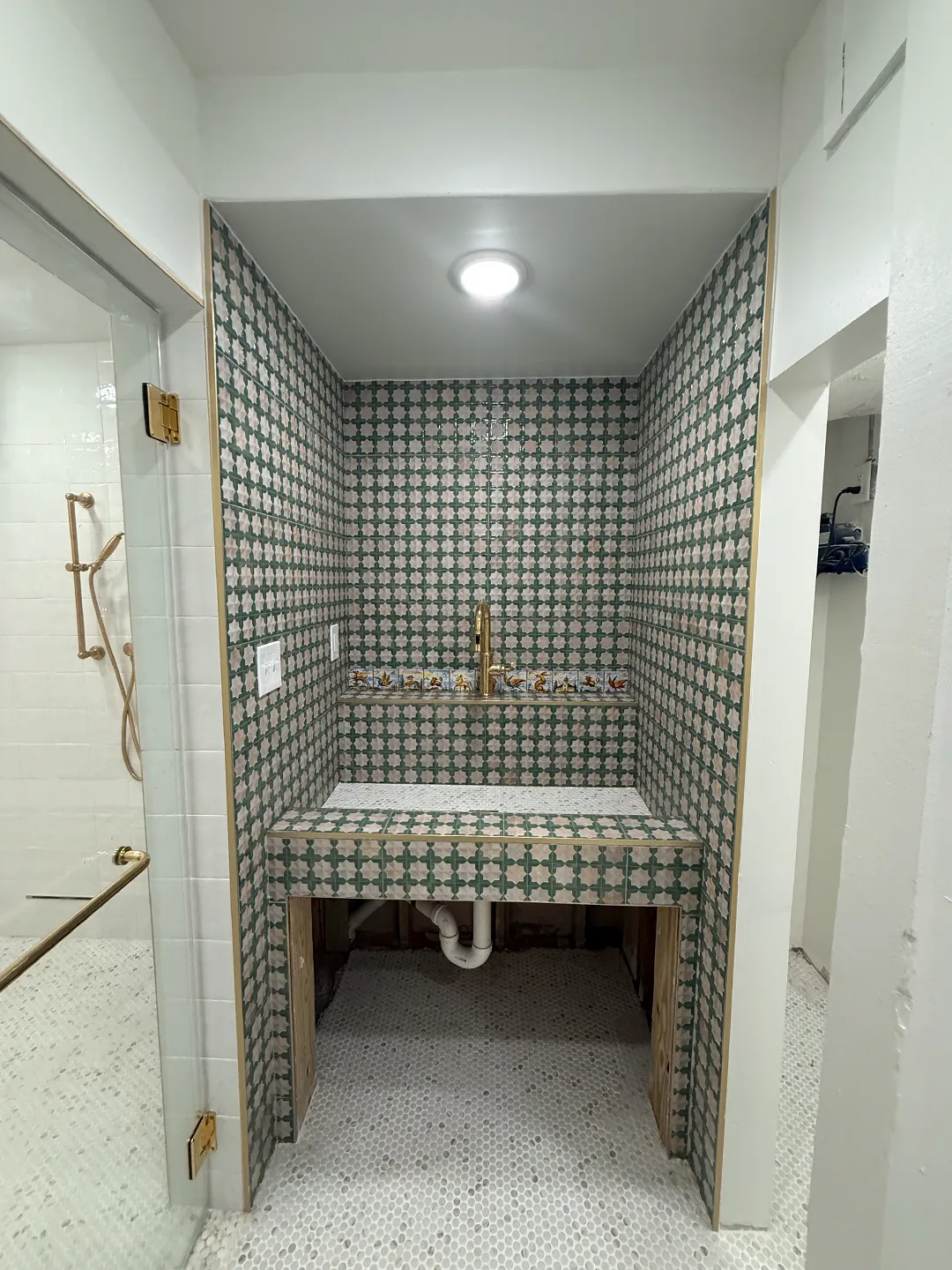 Detailed tile installation around a custom bathroom vanity