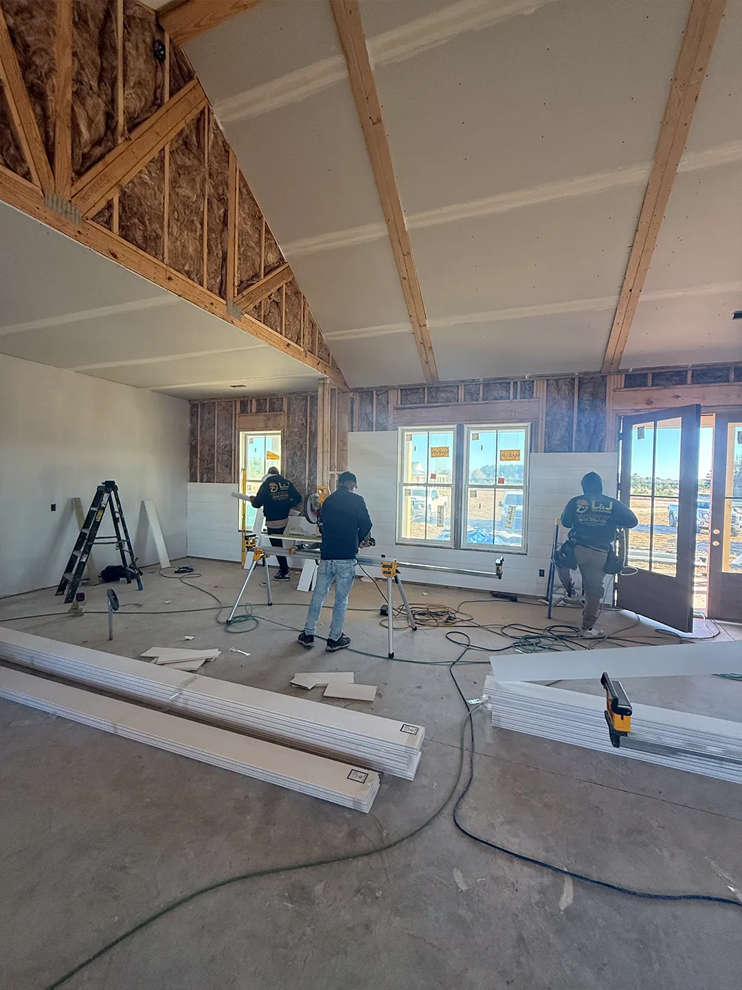 Drywall installation and joint finishing in progress during an interior renovation
