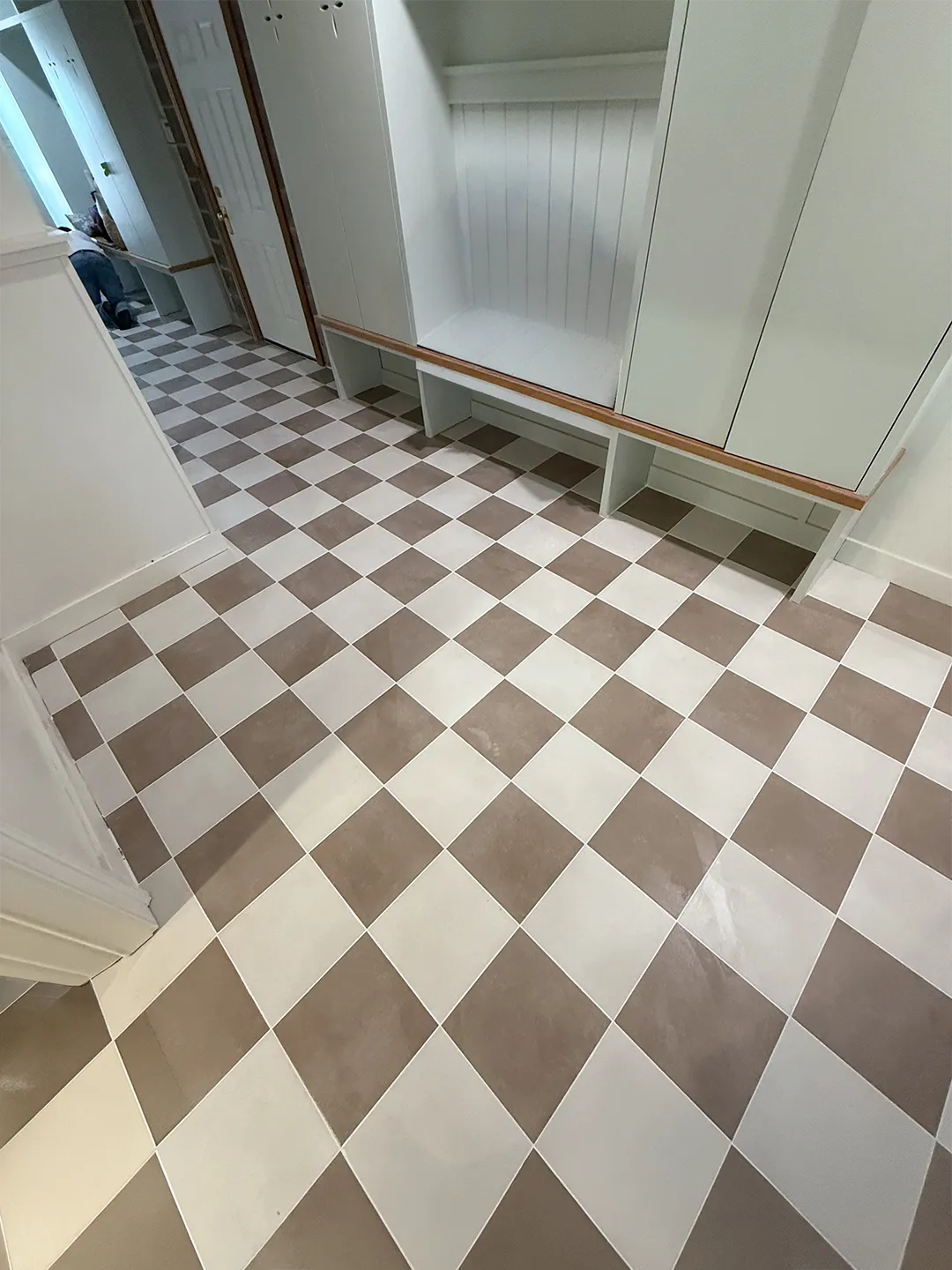 Completed checkerboard tile floor with custom built-in cabinetry